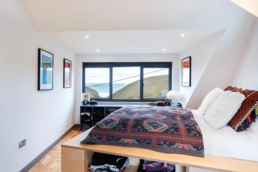 bedroom with raised bed looking towards sea view
