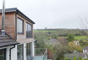 Photo of a timber cladded dormer with views over the surrounding countryside