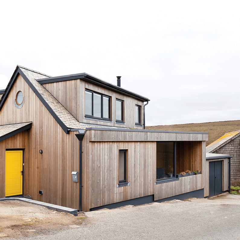 view of the front elevation of modern timber clad dormer bungalow 