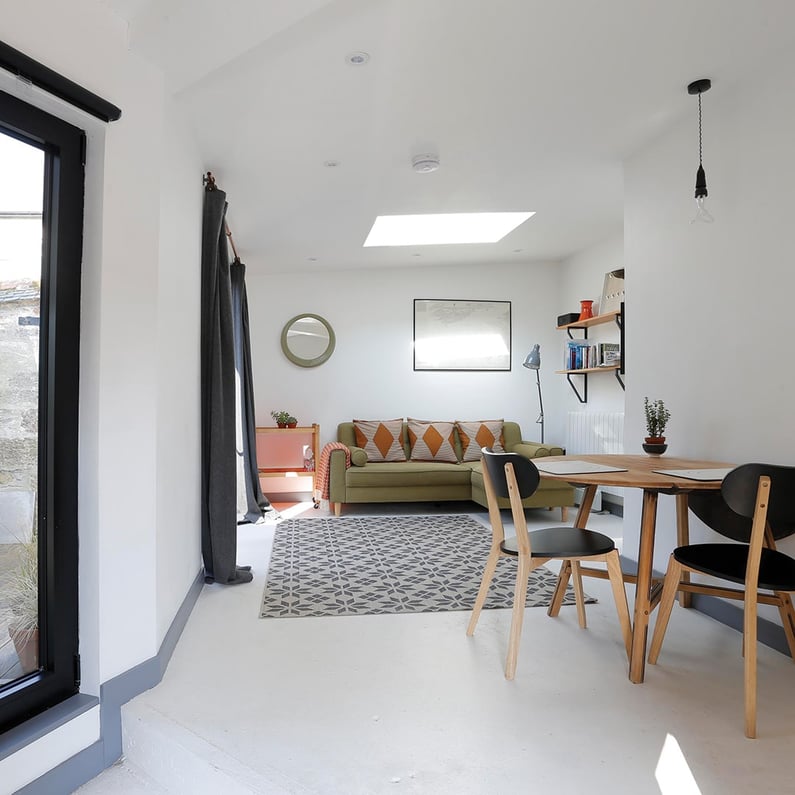 dining table with green sofa in background