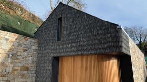 Main entrance showing featured slate finish and curved timber door