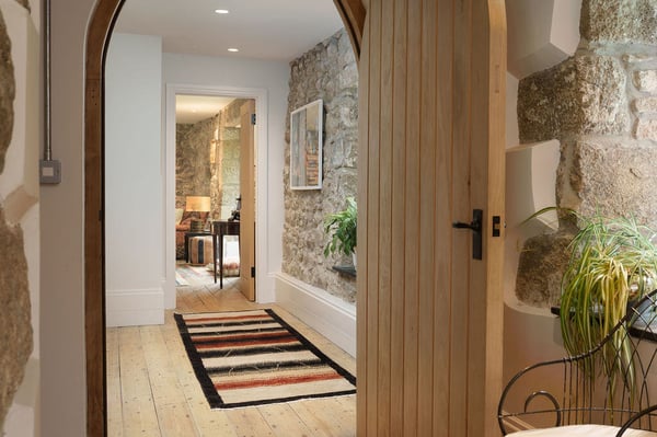arched wooden doorway leading into hallway