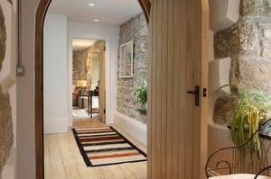 arched wooden doorway leading into hallway