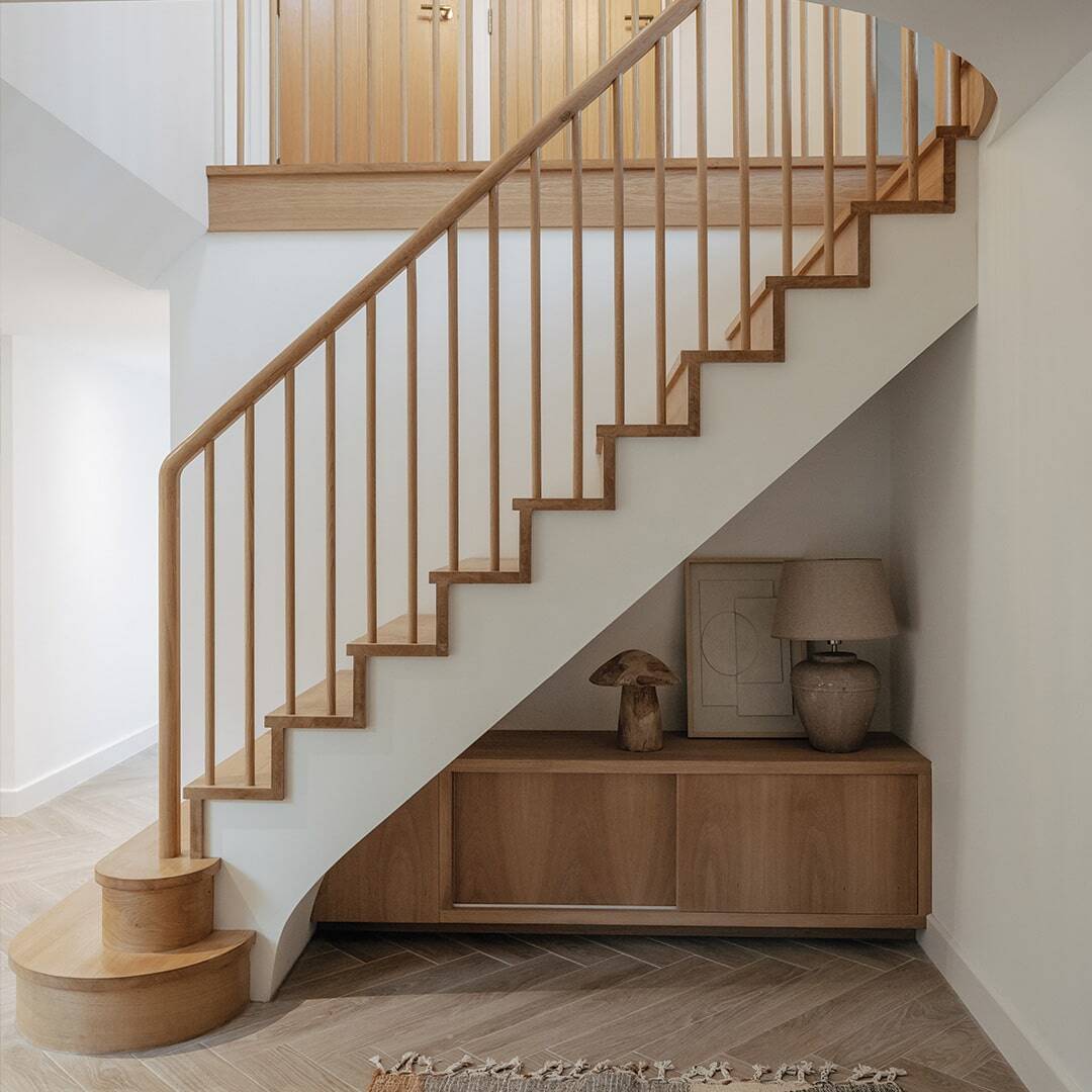 wooden stairs with curved handrail