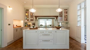 kitchen island with hanging pendant lights either side and sink in middle