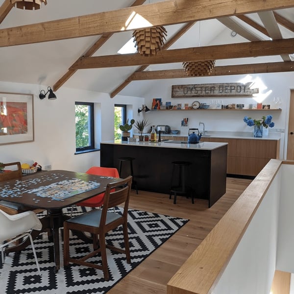 traditional kitchen with island and open timber trusses