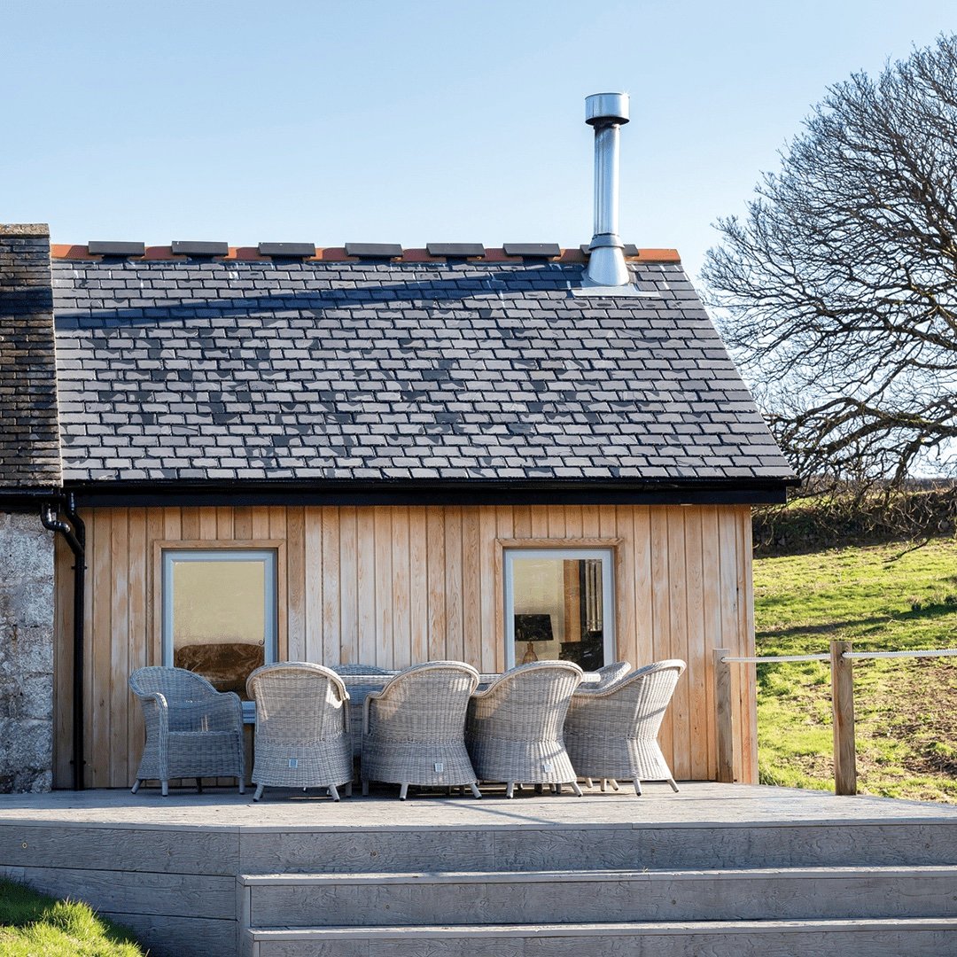 traditional side extension with timber cladding and slate roof