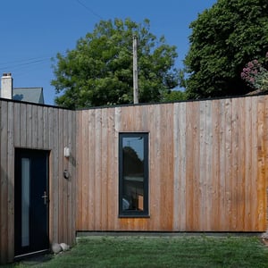 contemporary timber cladded extension with clipped roof line